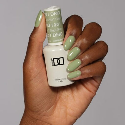 Hands wearing 1001 Sage Groovin' Gel & Polish Duo by DND