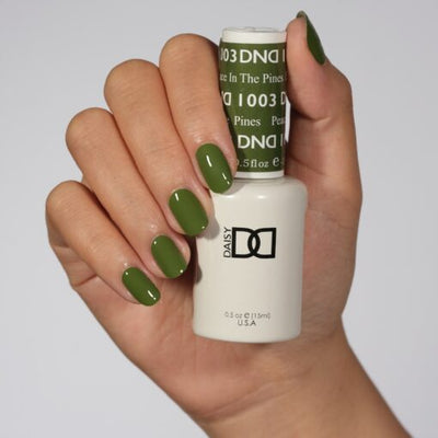 Hands wearing 1003 Peace In The Pines Gel & Polish Duo by DND