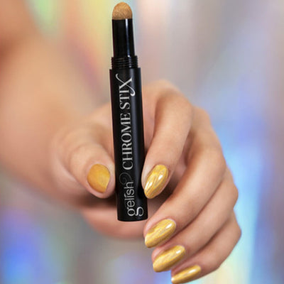 Hands wearing Gold Holo Chrome Stix by Gelish