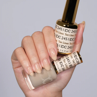 Hands wearing DND DC Gel 2451 Tan Lines