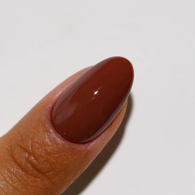 Hands wearing DND DC Gel 319 Coffee Bean