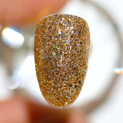 Hands wearing DND Gel 401 Golden Sahara Star