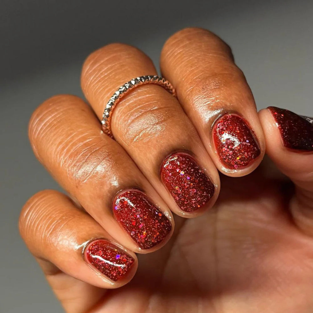hands wearing DND Duo gel polish 675 Red Eyeshadow