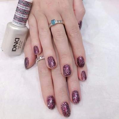 Hands wearing DND Gel 409 Grape Field Star