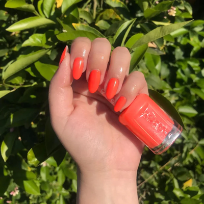 Hands wearing DND Gel 426 Pastel Orange