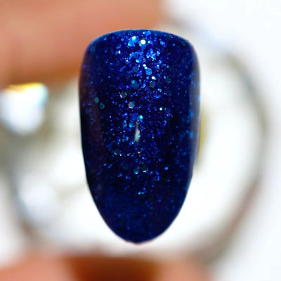 finger wearing DND Gel Polish - 583 Blue Amber