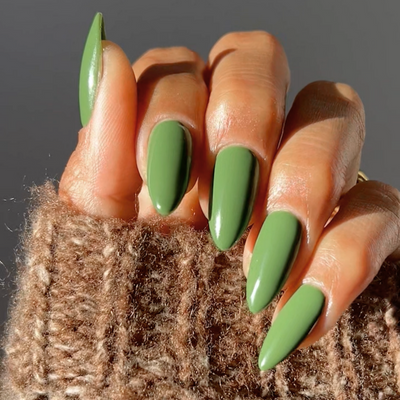 Hand wearing DND Diva Olive Green 284 gel polish