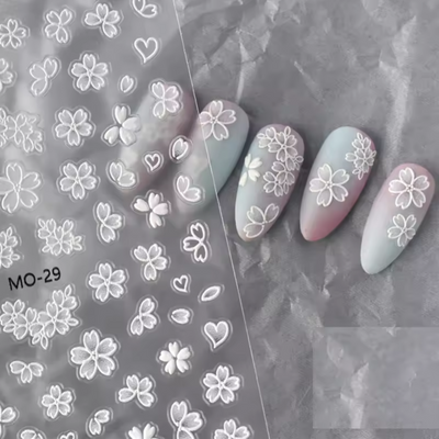 Nail art stickers with floral designs on a gray background