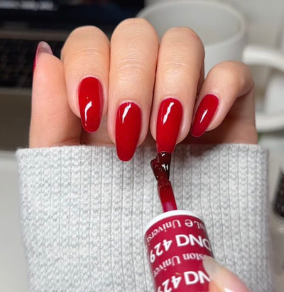 hands wearing 429 Boston University Red Gel Polish by DND
