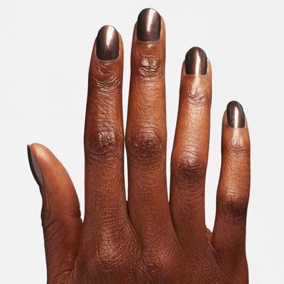 Hands wearing Q03 Hot Toddy Naughty Polish by OPI