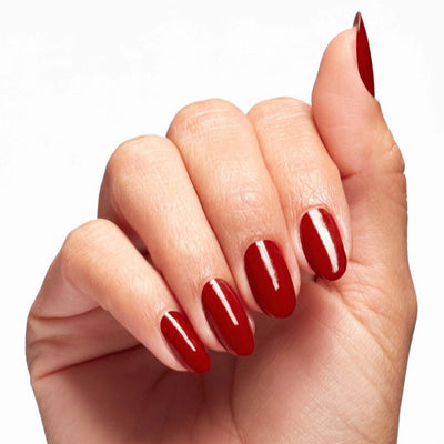 Hands wearing Q05 Rebel With A Clause Polish by OPI