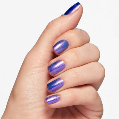 Hands wearing Q25 Shaking My Sugarplums Infinite Shine by OPI