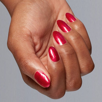 Hands wearing H025 Kiss My Aries Lacquer by OPI