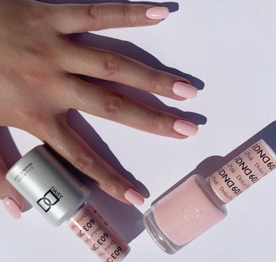 hand wearing DND Gel & Polish duo bottles 601 Dolce Pink