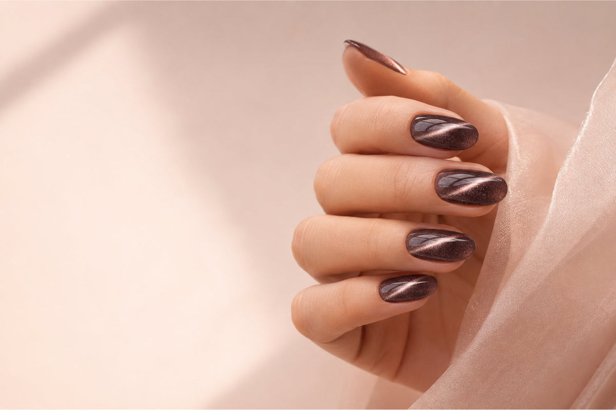 Elegant cat eye gel nails with a reflective magnetic effect on a neutral beauty blog background.
