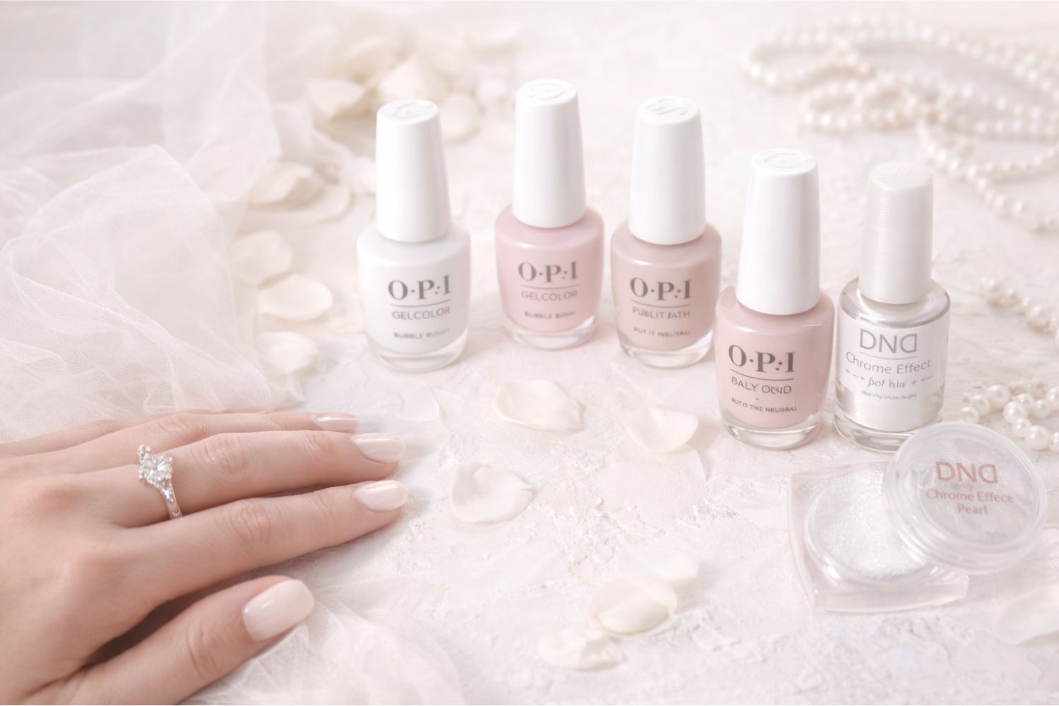 soft aesthetic bridal flatlay with wedding nail polish shades milky white pink nude pearls and engagement ring