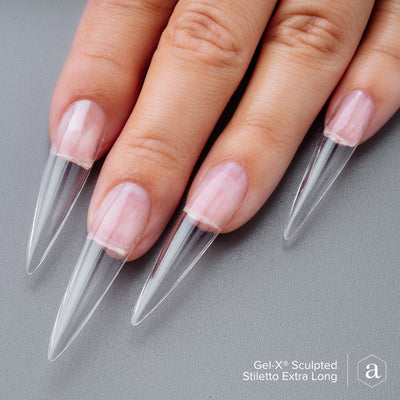 Hands wearing Sculpted Extra Long Stiletto 2.0 Tips by Apres