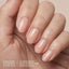 Model wearing Aprés Soft Gel Builder Gel Glow, featuring soft peachy nude clean girl nails with a glossy structured gel manicure.