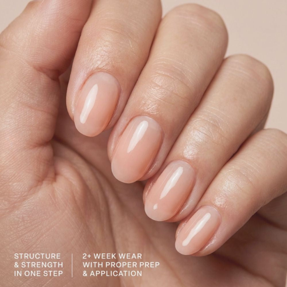 Model wearing Aprés Soft Gel Builder Gel Glow, featuring soft peachy nude clean girl nails with a glossy structured gel manicure.