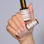 Hands wearing DND DC Gel 2437 Satin Luna