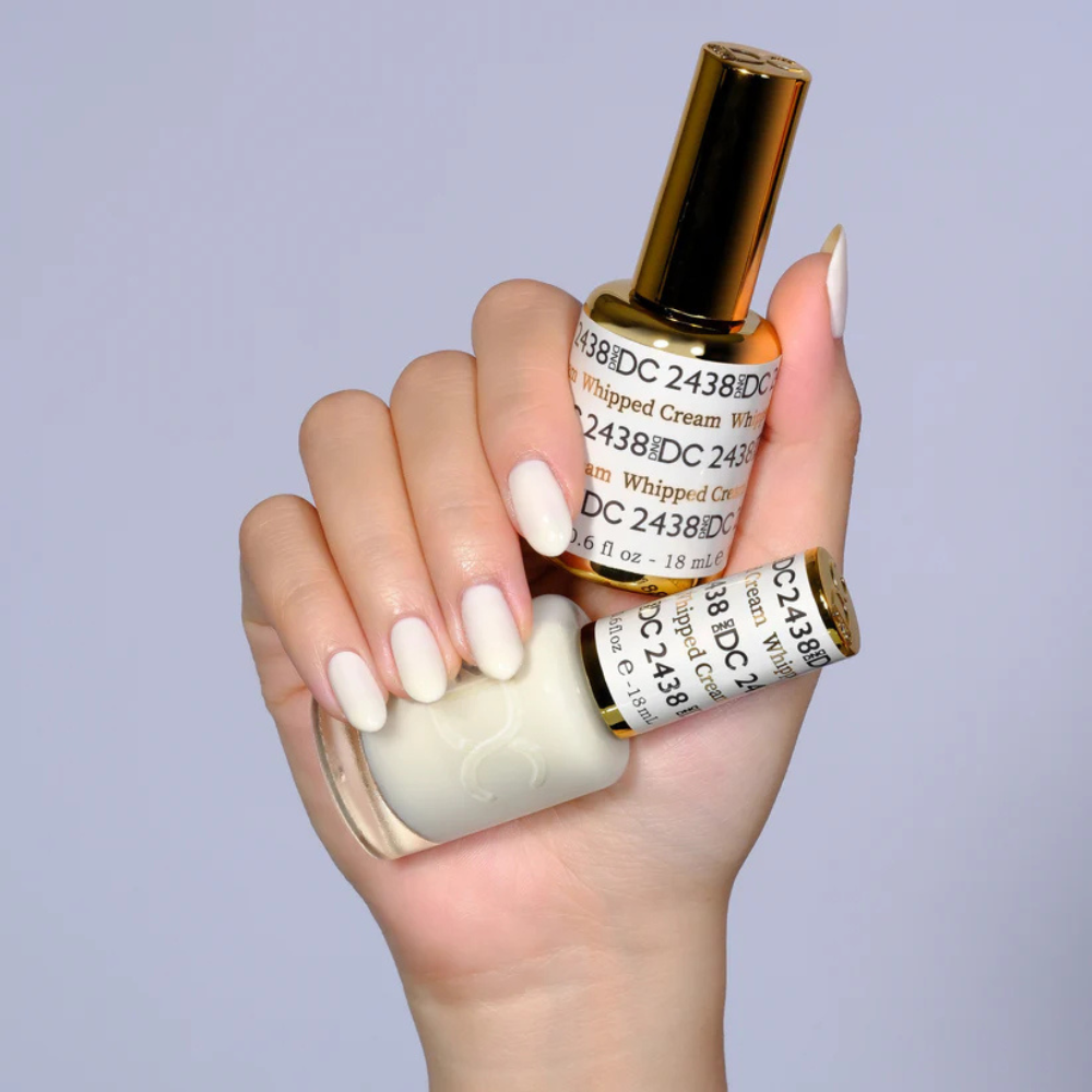 Hands wearing DND DC Gel 2438 Whipped Cream
