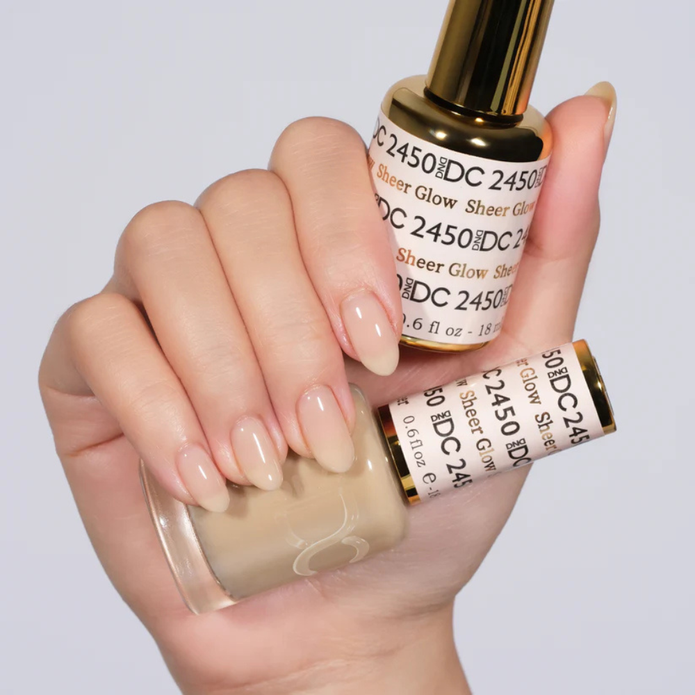 Hands wearing DND DC Gel 2450 Sheer Glow2450 Sheer Glow