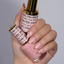 Hands wearing DND DC Gel 2461 Milky Pink