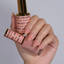 Hands wearing DND DC Gel 2464 Nude Galore