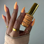 Hands wearing DND DC Gel 2538 Mandarin Glow