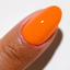 Hands wearing DND DC Gel 2540 Orange Soda