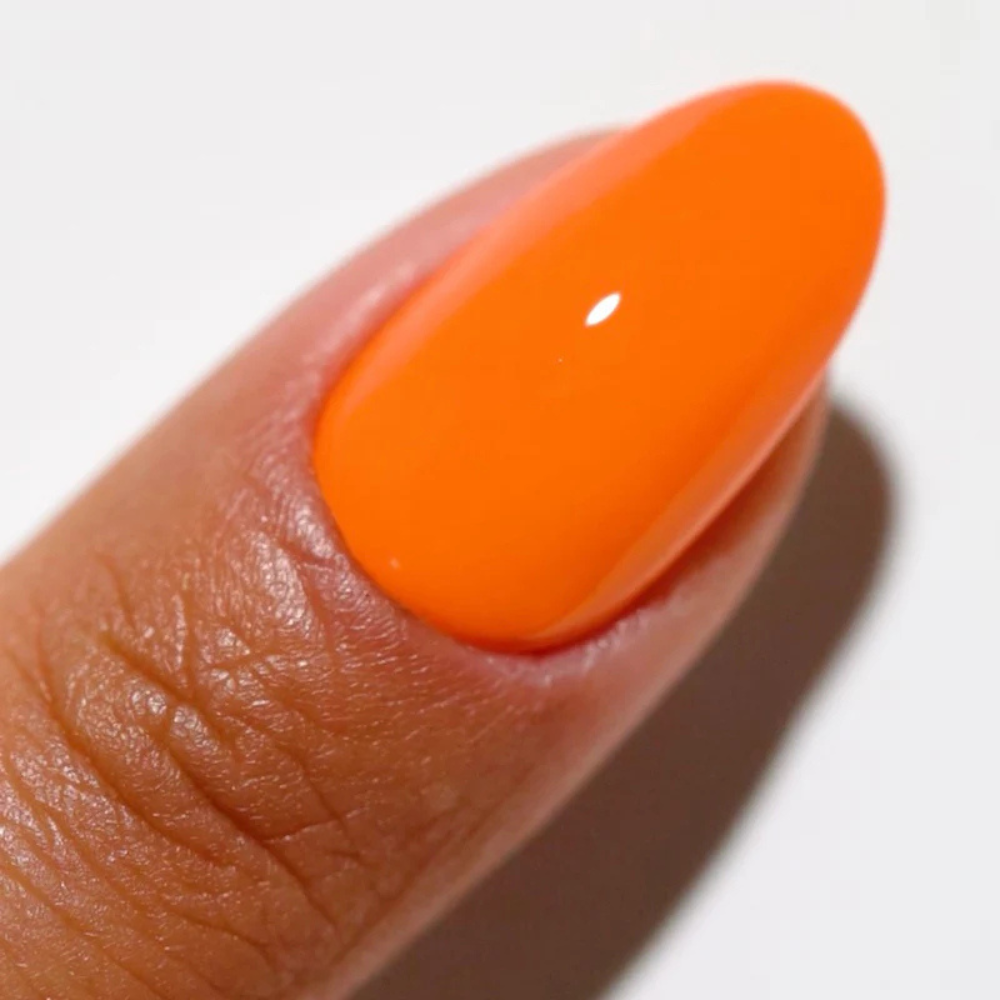 Hands wearing DND DC Gel 2540 Orange Soda