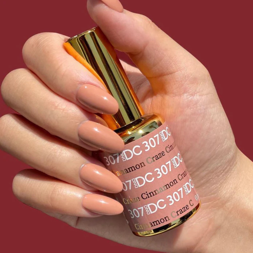 Hands wearing DND DC Gel 307 Cinnamon Craze