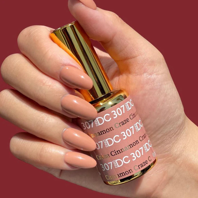Hands wearing DND DC Gel 307 Cinnamon Craze