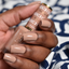 Hands wearing DND DC Gel 312 Freckle