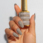 Hands wearing DND DC Gel 315 Foxy Gray