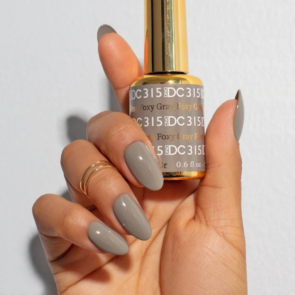 Hands wearing DND DC Gel 315 Foxy Gray
