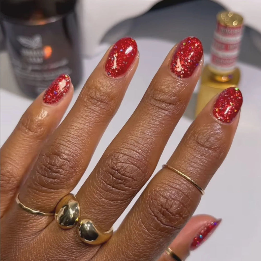 Hand with red glittery nails 