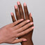 hands wearing 113 Cupcake Frosting Gel & Polish Diva Duo by DND