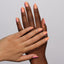 hands wearing 168 Tangy Apricot Gel & Polish Diva Duo by DND