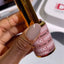 finger wearing DND DC Gel - 103 Bamboo Brown