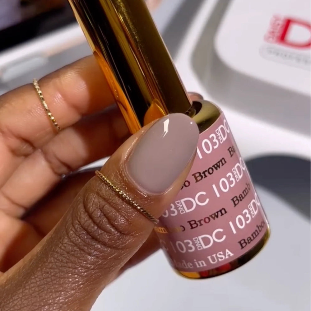 finger wearing DND DC Gel - 103 Bamboo Brown