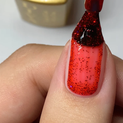 Close-up of a red glittery nail 