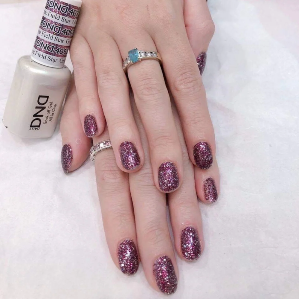 Hands wearing DND Gel 409 Grape Field Star