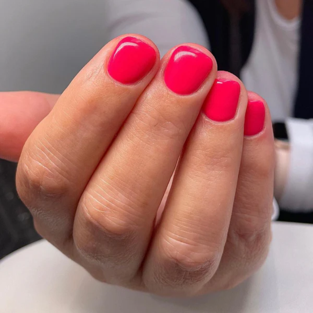 Hands wearing DND Gel 413 Flamingo Pink