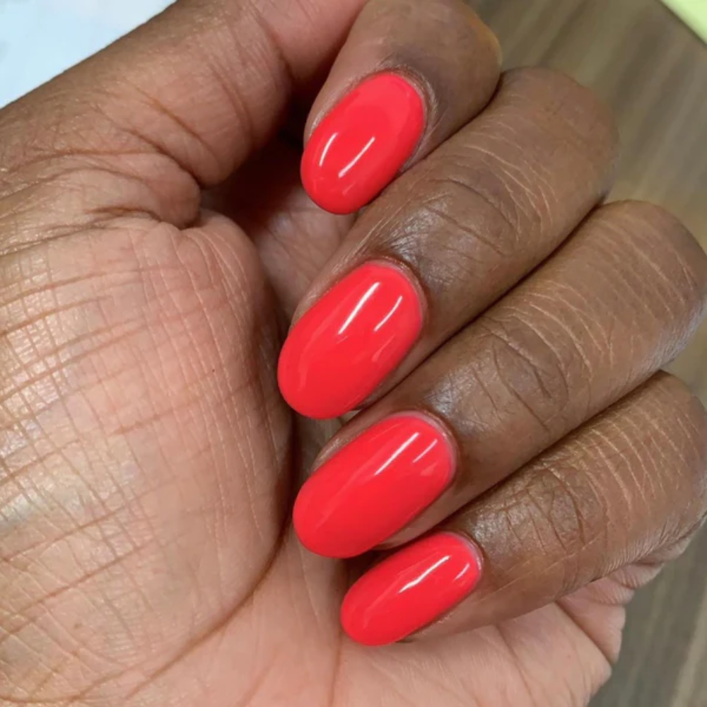 Hands wearing DND Gel 414 Summer Hot Pink