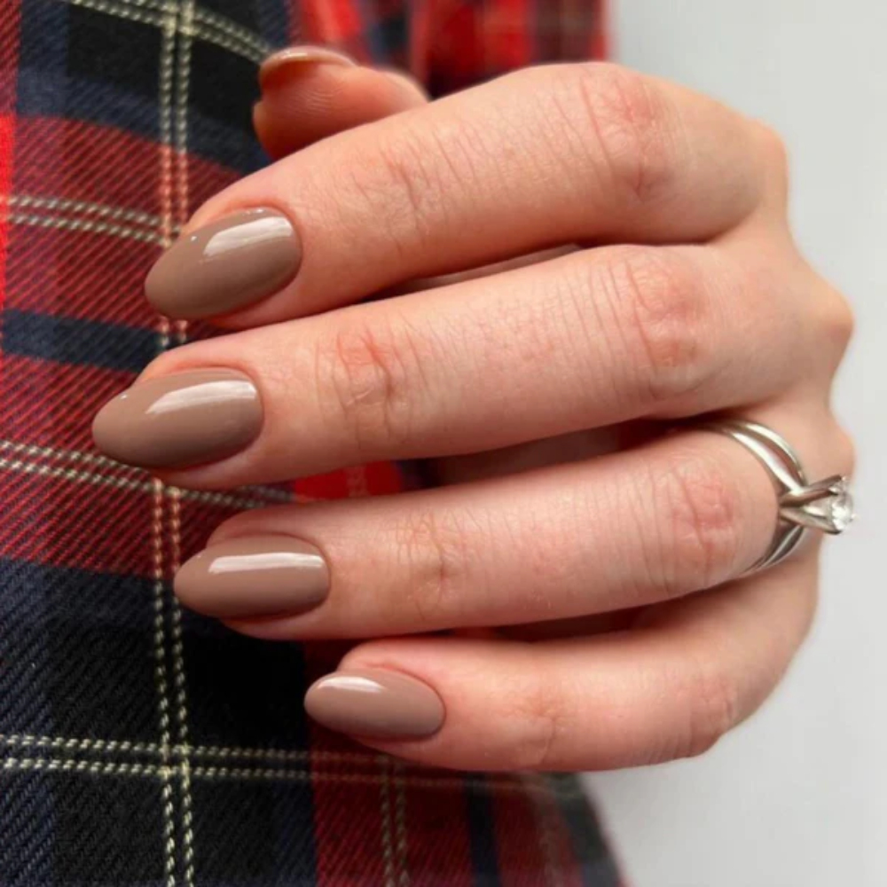 Hands wearing DND Gel 418 Butternut Squash
