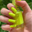 Hands wearing DND Gel 424 Lemon Juice