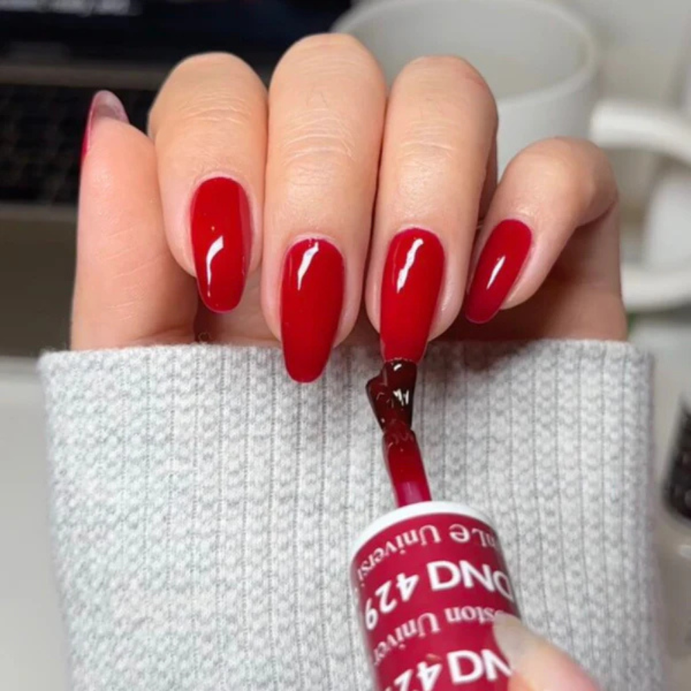 Hands wearing DND Gel 429 Boston University Red