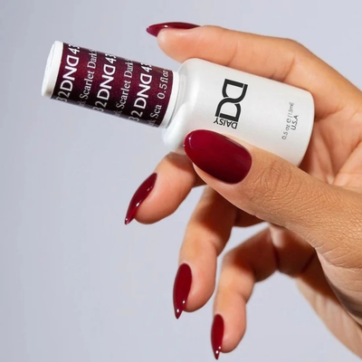 Hands wearing DND Gel 432 Dark Scarlet