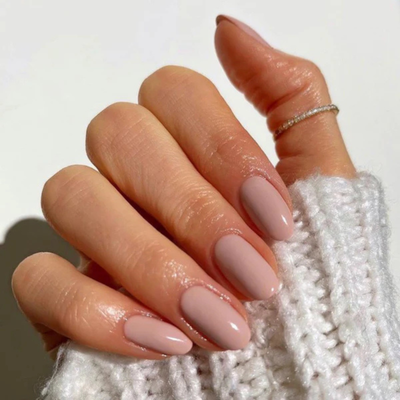 Hands wearing DND Gel 440 Papaya Whip
